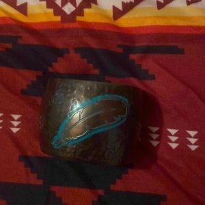 It’s a bracelet with a feather on it